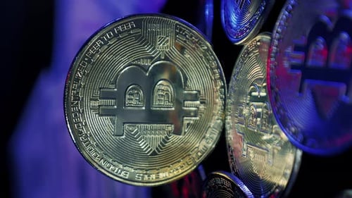 Cryptocurrency. Rotating shining bitcoin on dark background. Vertical video