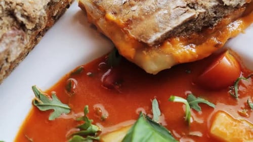 Delicious toasted bread sandwich with soup on plate