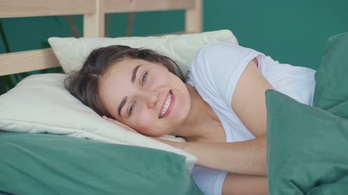 Happy Woman Smiling in Bed