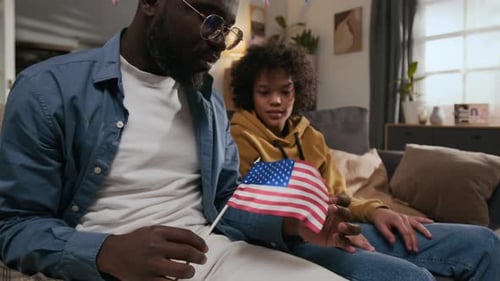 Family Celebrates with American Flag Indoors
