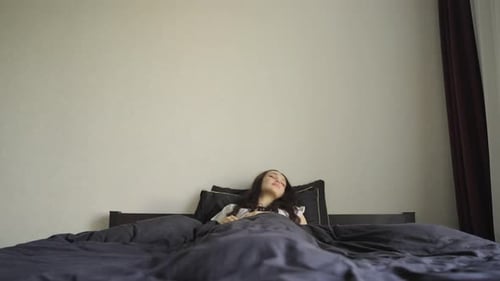 Woman Sleeping Peacefully in Bed at Home