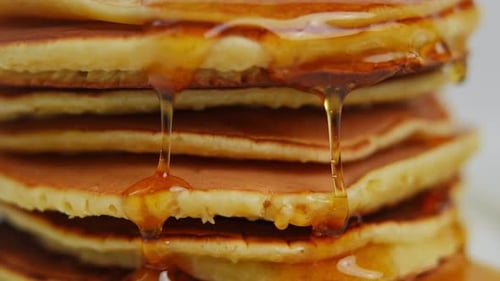 Pancakes with Syrup Drizzling Close Up