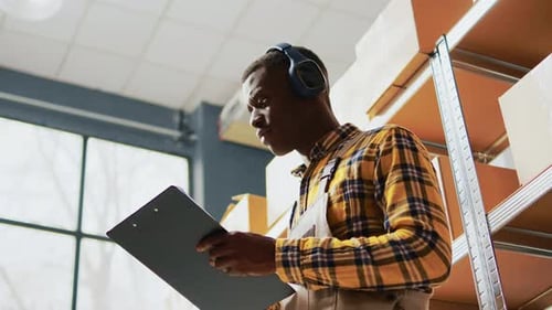 Young Man Singing and Dancing in Storage Room