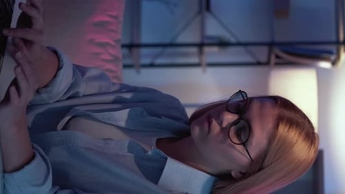 Woman Working on Laptop in Modern Office at Night