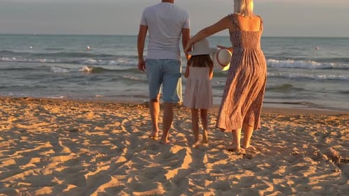 Family Walk on Sand Beach at Sea at Sunset Summer Vacation Travel Tourism