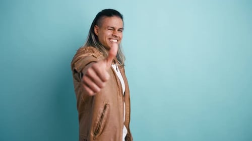 Smiling Young Man Giving Thumbs Up Approval