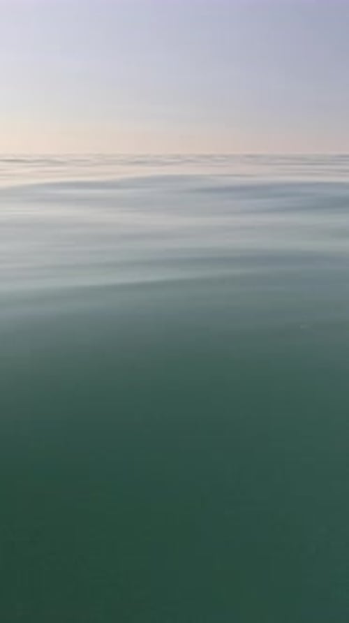 Water Ripples Calm Open Ocean Surface Under Tranquil Sky Vertical Video