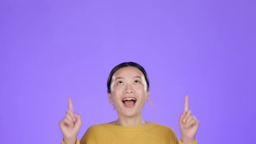 Woman Smiles and Points Upward