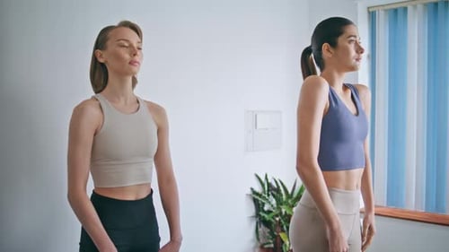 Women Doing Shoulder Shrug Exercises in Home