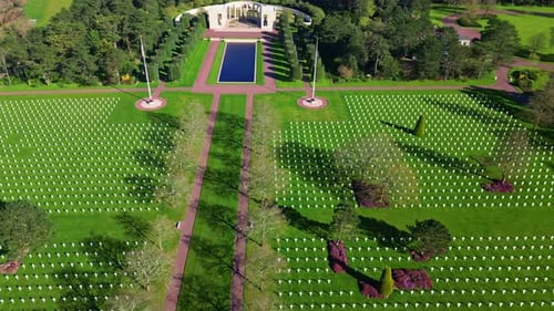 Lateral drone movement over the World War II military Normandy American Cemetery with a memorial bui