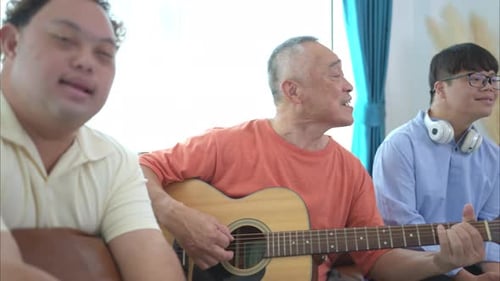 Family sings and plays the guitar together