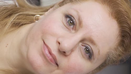 Vertical Video of Close-up portrait of a smiling mature senior woman.