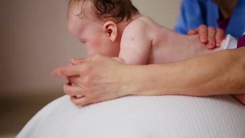 Infant Receives Gentle Massage from Healthcare Professional