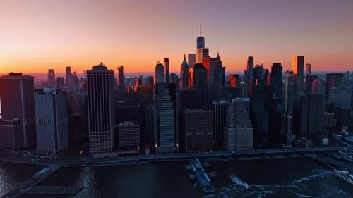 Skyline of Manhattan at sunset. Stunning pink sky at backdrop.