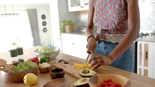 Woman Prepares Healthy Salad in Bright Kitchen