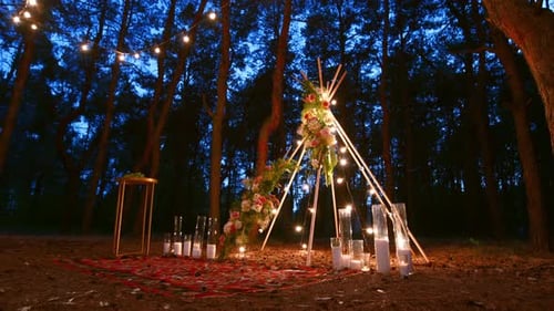 Festive String Lights Illumination on Boho Tipi Arch Decor on Outdoor Wedding Ceremony Venue in Pine