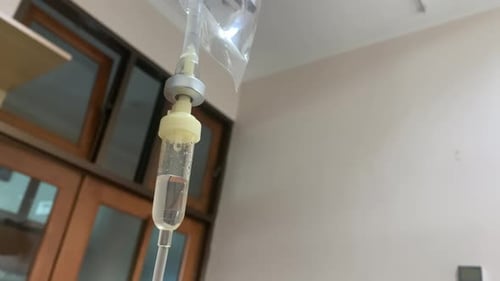 IV Bag Drip Intravenous medication for hospital use with patient room background