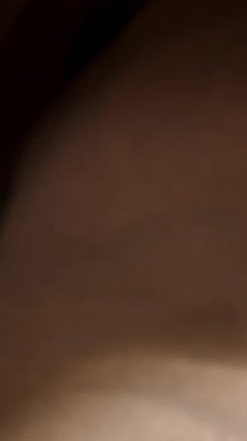 Vertical video. Chocolate protein powder and measuring spoon on the table, macro slider. The camera