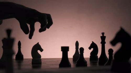 Silhouette of a Man Hand Over Knight Piece Grabbing and Grind It in Fury