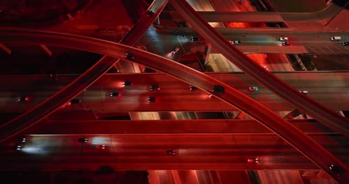 Transport rides by the highways lit with red light at night.