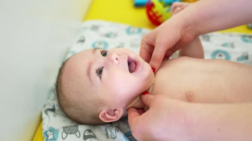 Infant Receives Massage on Changing Table