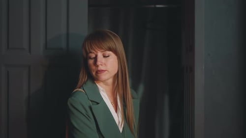 Woman with long hair enters a dark room