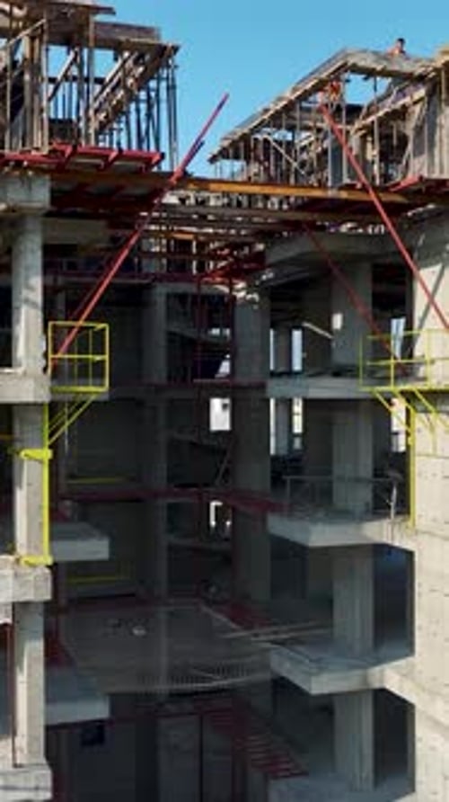 Vertical Drone View Urban Construction Scene with Organized Sections and Active Crew