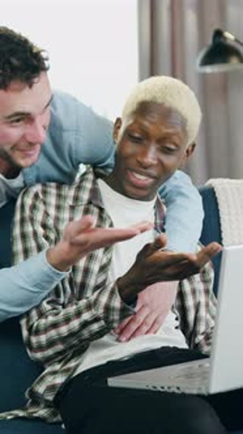 Smiling Couple Video-Calling on Laptop in Cozy Home
