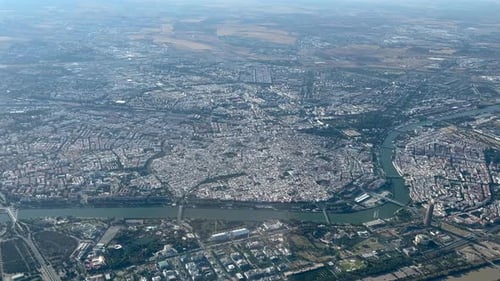 Aerial spinning view of Seville city, Spain, shot from an airplane