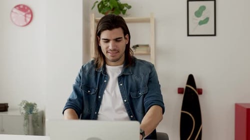 Young Freelancer Man Working on Laptop From Home Office