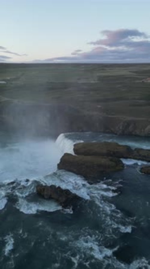 Aerial view of waterfall and rocks, Iceland.
