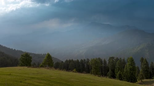 Scenic Mountain Landscape with Rolling Hills and Stormy Clouds