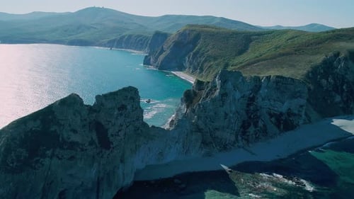 Aerial Panoramic View of Cliffs and Huge Rocks at Seaside and Waves Crashing to the Coast Beautiful