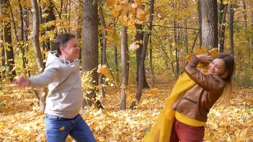 Young Family Plays Together in Autumn Forest