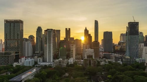 day to night time lapse of high-rise buildings cityscape near Witthayu road with sunset in Bangkok
