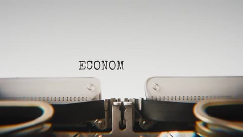 Old mechanical typewriter typing Economic Forum in a close-up view.