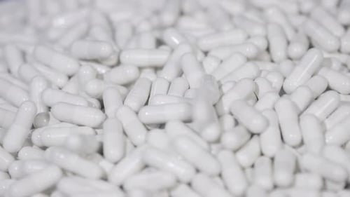 Pill capsules fall on the surface