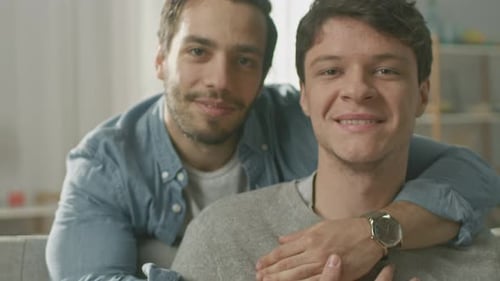 Affectionate Young Couple Embracing Indoors with a Smile
