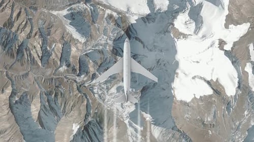 Avión volando sobre terreno montañoso con picos nevados