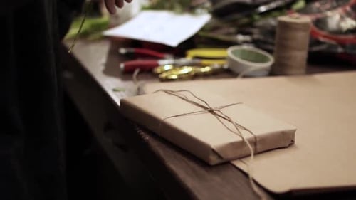 Close Up Gift Wrapping With Twine and Greenery