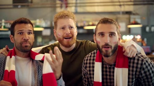 Three Adult Men Reacting with Disappointment in Bar
