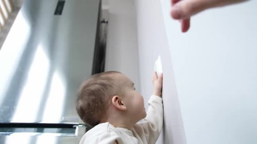 Baby Smiles at Safety Latch Installation in Kitchen