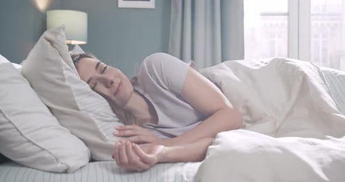Woman Sleeping Peacefully in Bedroom