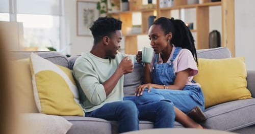 Couple Relaxing and Chatting on Living Room Couch