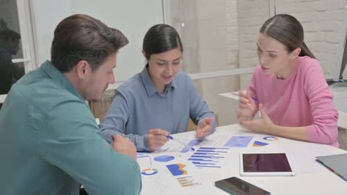Rear View of Multi Ethnic People Doing Paperwork