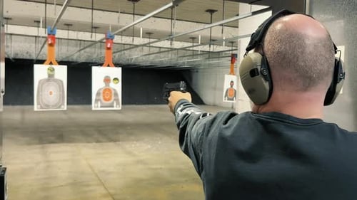 Shooting Range Practice Person Practicing Firearm Shooting at Indoor Range Targets