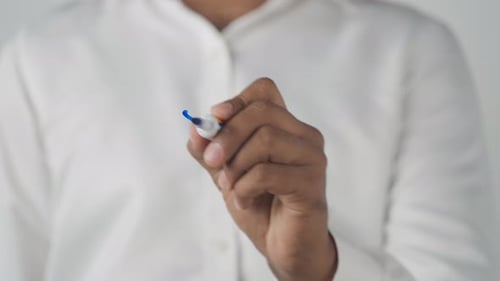 Hand Writes the Word Yes With a Blue Marker