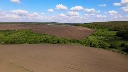Plowed Bare Agricultural Field with Cultivated Fertile Soil Prepared for Seeding Crops in Spring