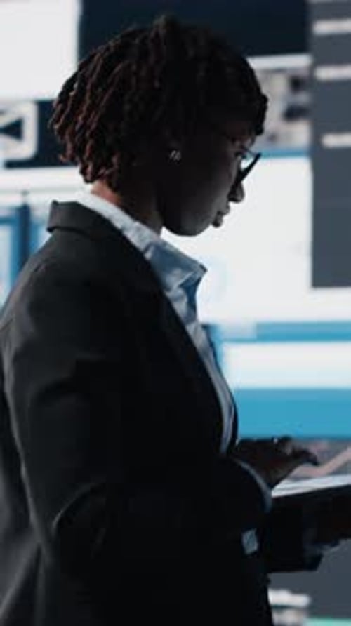 Vertical Video Manager Evaluating Business Market Graphs Using Laptop Software