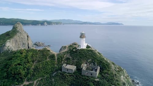 Aerial Tilt View of an Old Lighthouse on the Cliff on Pacific Coast Beautiful Panoramic Seascape